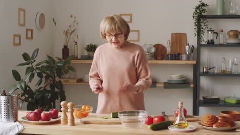 senior woman cooking and telling recipe on camera