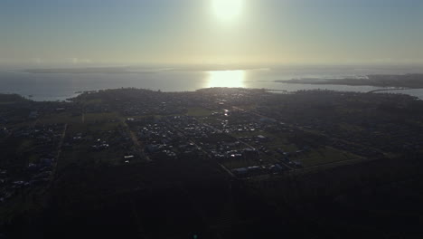 wide aerial view of the small rural town of federación. uruguay river. entre rios, argentina. 4k.