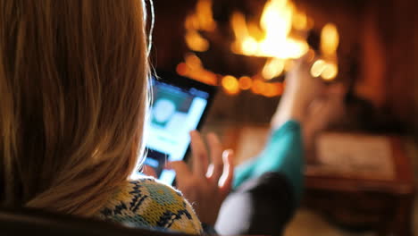 Use-A-Tablet-By-The-Fireplace-In-A-Cozy-Home-Environment