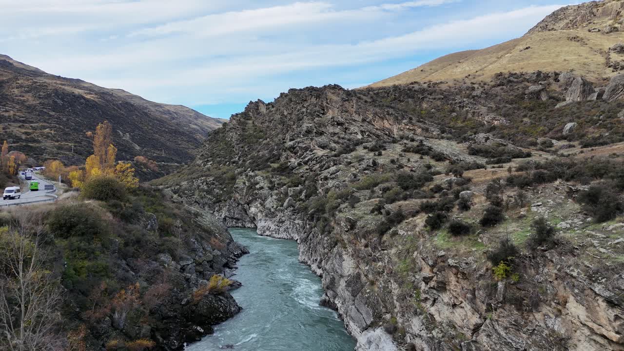 Aerial view of Kawarau Gorge River in autumn, showcasing vibrant foliage and rugged landscape under soft natural lighting