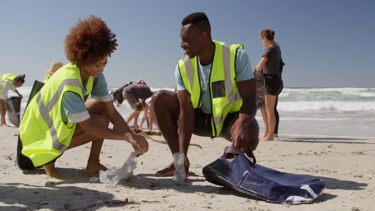 Volunteers cleaning beach on a sunny day 4k