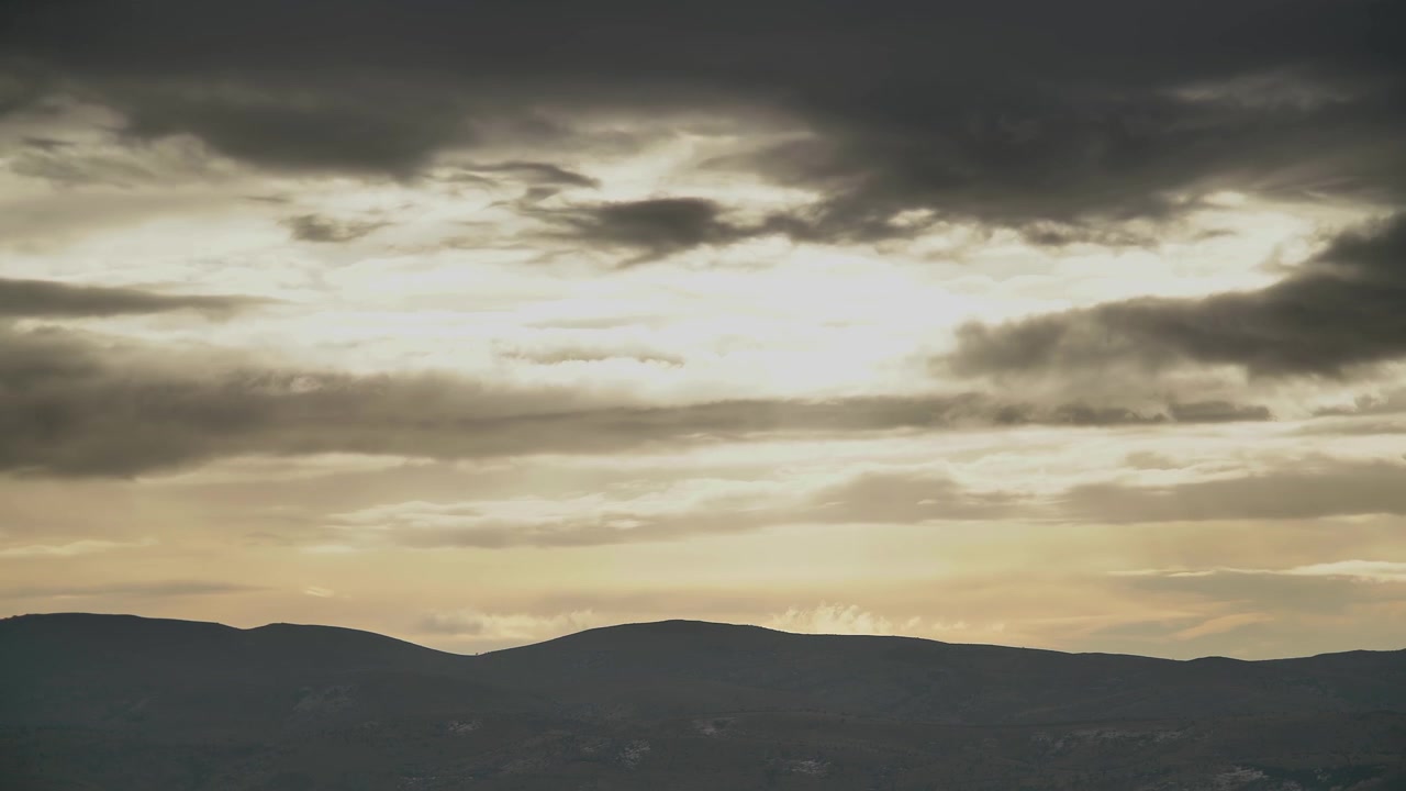 Time Lapse of Stormy Clouds Moving Over Mountain Silhouette