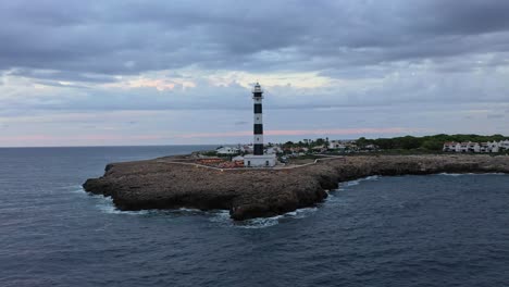 aerial orbit of artutx lighthouse in menorca spain