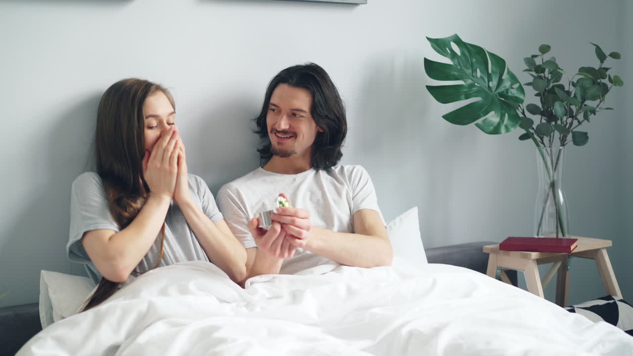 Couple Celebrating Engagement in Bed
