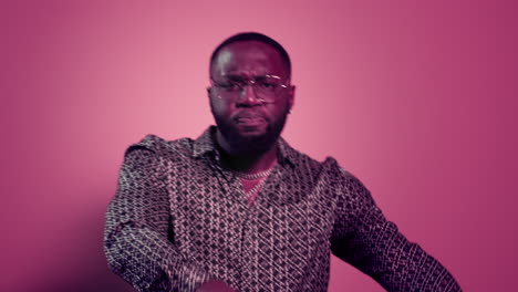 african american man dancing on pink background. afro guy having fun in studio