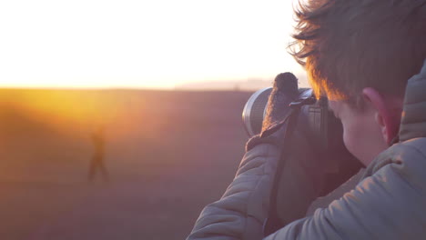 young photographer taking a picture in the icelandic wasteland