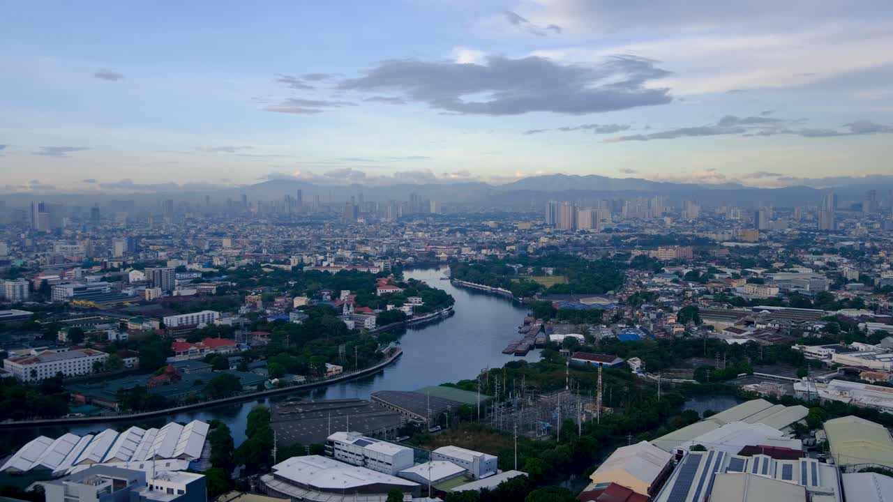 Aerial view of Pasig River winding through urban landscape of capital city of Manila Philippines