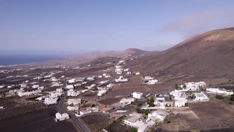 Aerial-shot-of-white-houses-town-and-the-ocean