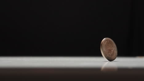 canadian penny spinning on tabletop