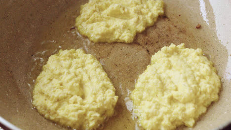 delicious shot of peruvian corn cakes cooking with boiling oil