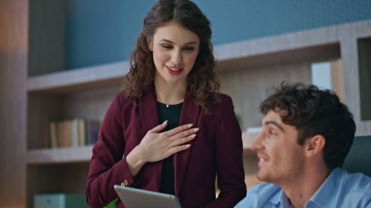 Colleagues talking online conference looking laptop webcam in office close up.