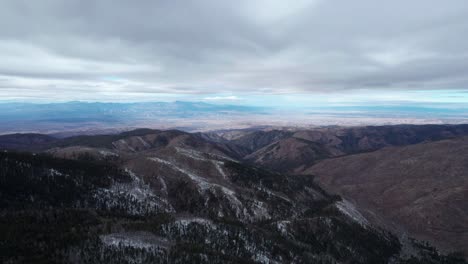 high elevation drone shot of a valley and mountains in the distance