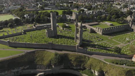 Aerial-drone-view-of-the-St-Andrews-Cathedral-and-cemetery-grounds-in-Scotland,-UK