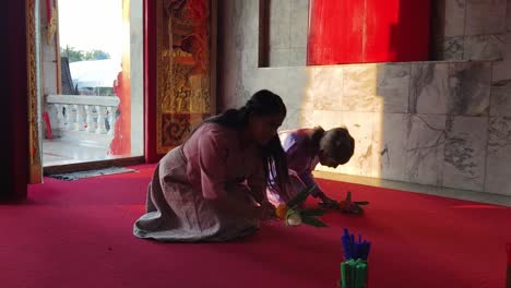 people praying in a thai temple