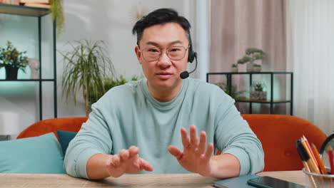 man with headset and glasses looking at camera