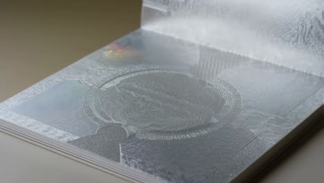 close-up of an open book with intricate silver patterns