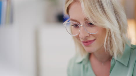 Happy-Woman-Working-on-Laptop-in-Office-Smiling