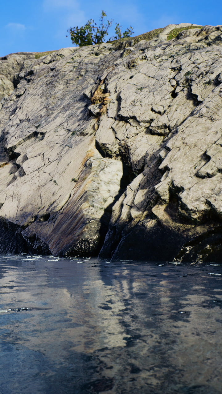 Rock formation near water with ripples and clear sky on sunny day