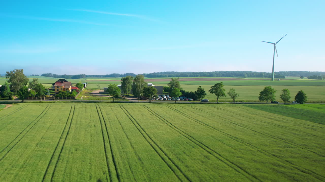 Peaceful farm with windmills, producing electricity. Drone