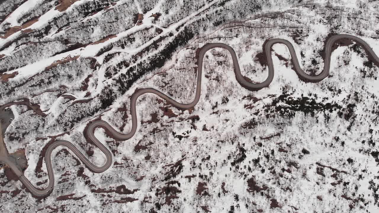 Aerial fly Mount Zao Stratovolcano, snowy winding Road and Rusty Terrain, Japan