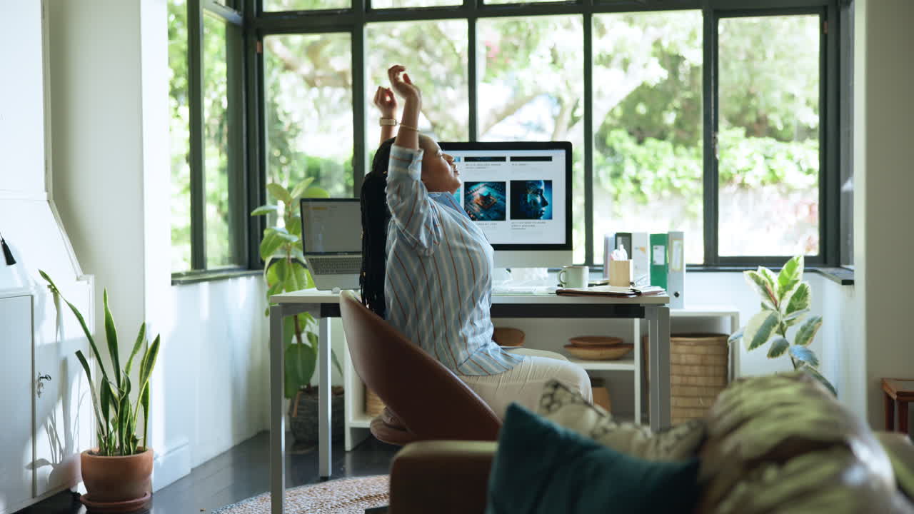 Woman Stretching While Working on Computer in Home Office