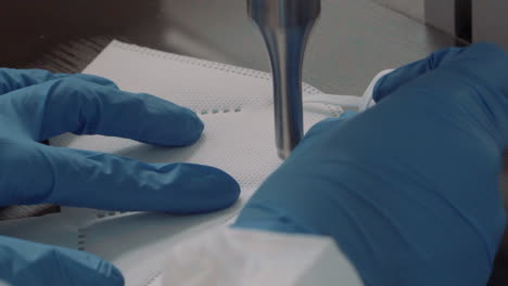 detail of a machine for gluing elastics for face masks