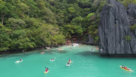 intrepid travelers kayaking on turquoise ubugon cove, el nido palawan