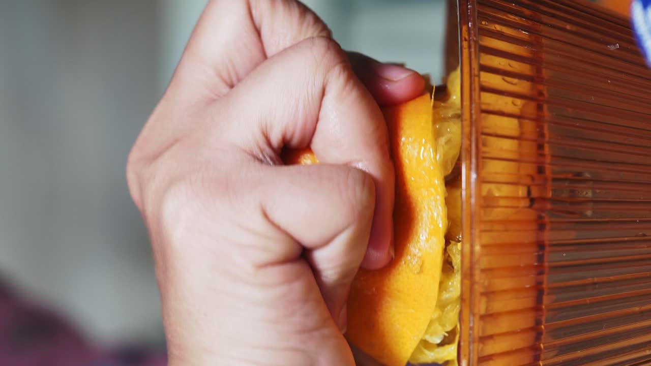 Hand Squeezing Orange for Juice