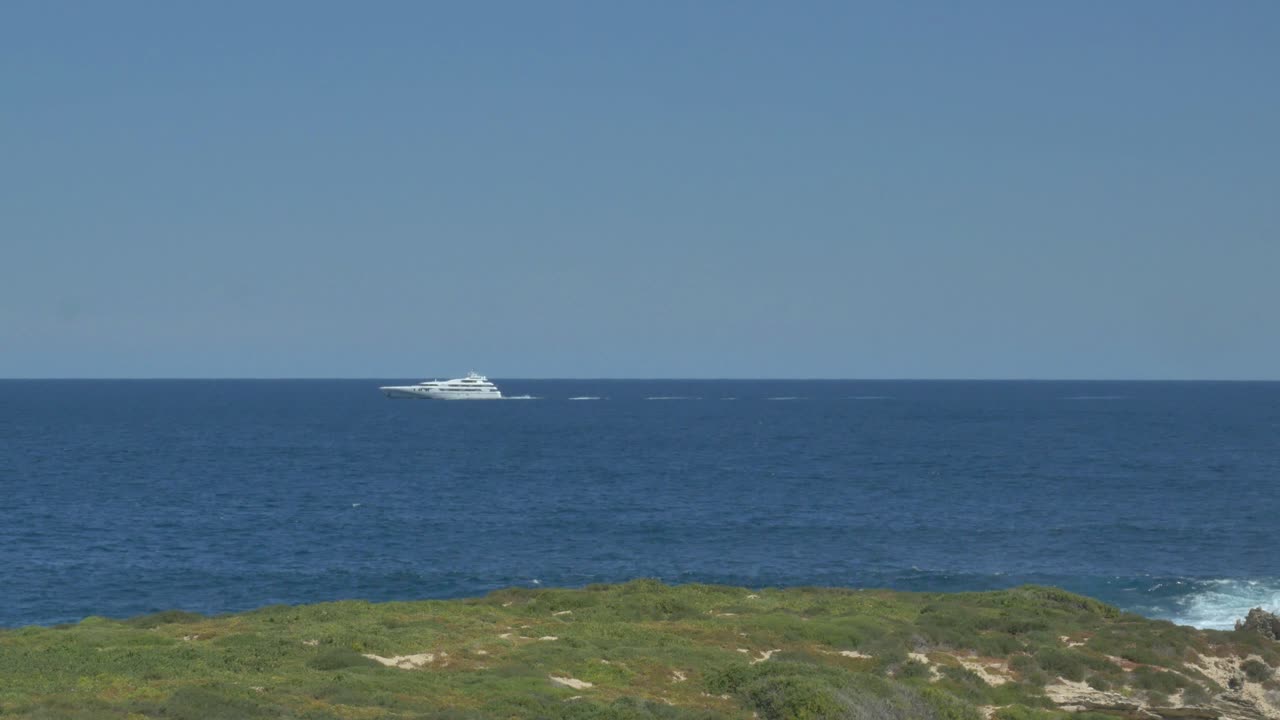 Luxury cruise yacht passes in the distance