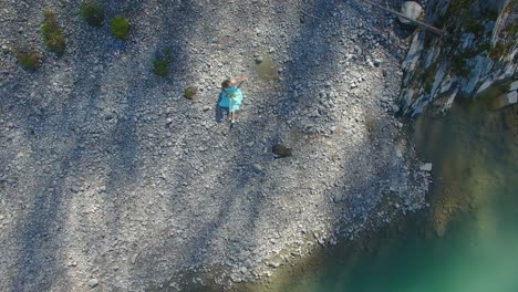 woman in a blue dress by the lakeside