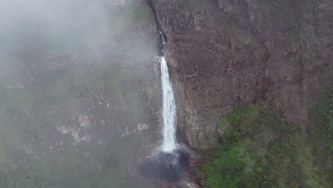 Aerial approaches Casca D'anta waterfall through thin gossamer cloud