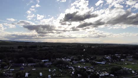 Rising-drone-shot-of-magnificent-clouds-over-a-small-town