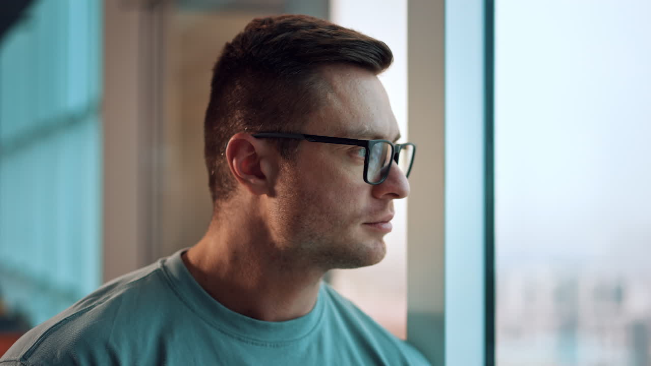 Man Looking Out Window