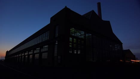 wide shot of a large warehouse or factory at dusk or sunset 4