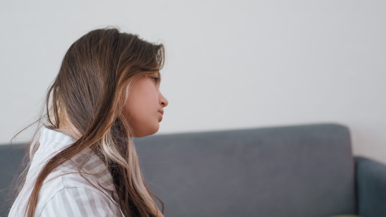 Casual Girl Under Cozy Blanket, Relaxed Female Figure Resting In Lounge, Calm Scene Of Woman Lying With Serene Posture, Peaceful Setting Showing Girl Basking In Gentle Lighting On Sofa
