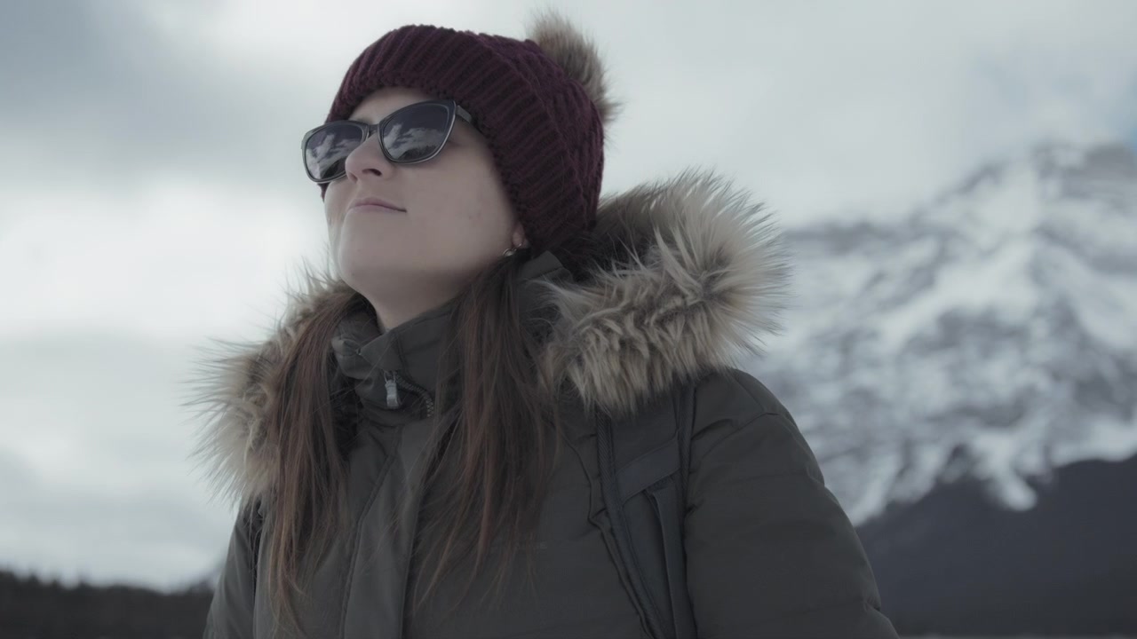 Young woman hiking in the Canadian Rocky Mountains in winter