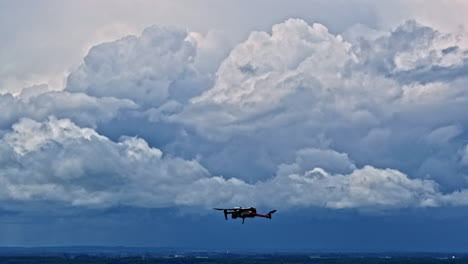 drone flying through dramatic thunderclouds against a light gray sky