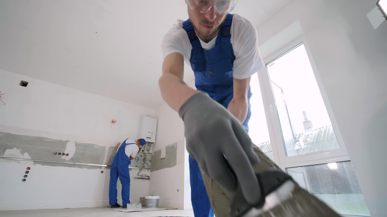 Installing ceramic floor tiles - measuring and cutting the pieces. Construction, renovation, repair apartment. Cuts tile. Tile cutting