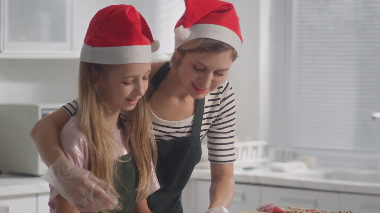 Mother Teaching Daughter to Knead Dough for Christmas Cookies