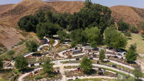 Low-descending-aerial-shot-of-a-tranquil-nature-garden-at-a-California-mortuary