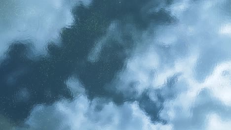 spinning artistic view of clouds reflecting above a distorted rippled water surface