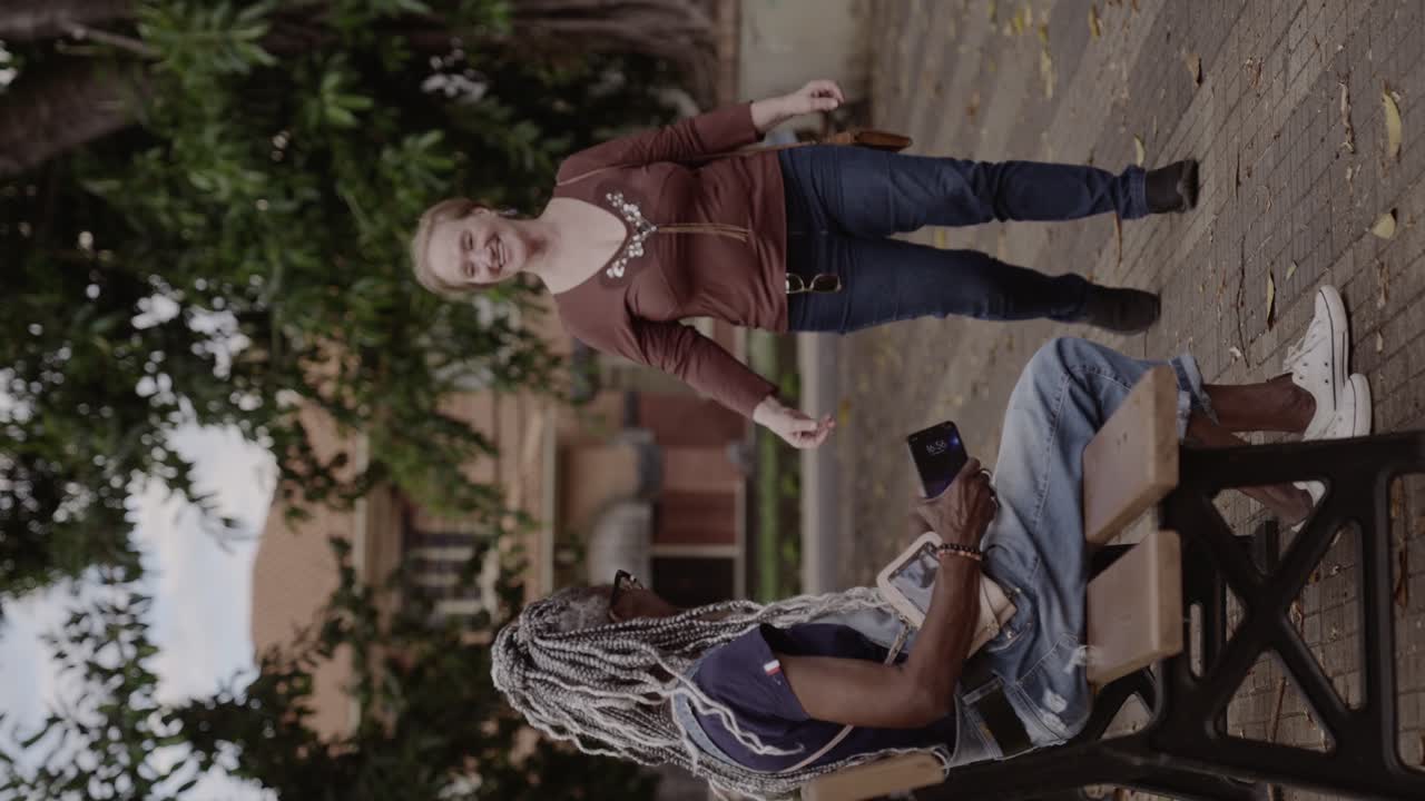 Friends meeting and hugging in a park