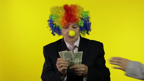 clown female businesswoman freelancer in wig holds money income and loses it