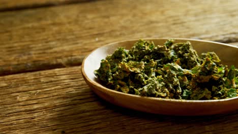 dried herbs in plate on wooden surface 4k 4k