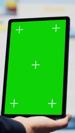 vertical video general director with a chroma key display reviewing performance metrics
