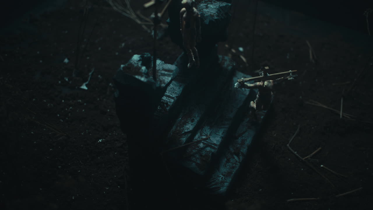 Miniature mummified dolls hanging on the gallows at night