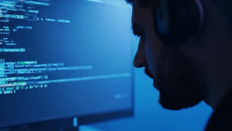 man coding on his computer
