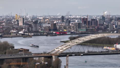 traffic flow over van brienenoord bridge, rotterdam skyline aerial view