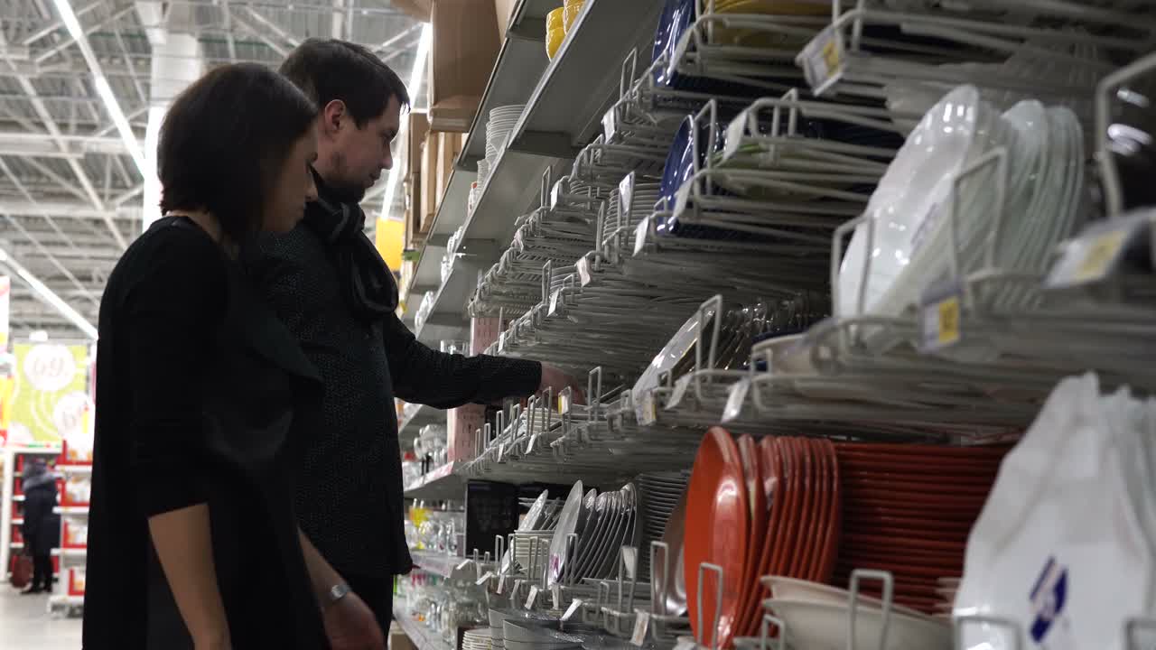 Couple Shopping for Dishes in a Supermarket