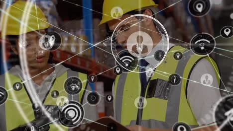 Animation-of-network-of-connections-with-icons-over-two-diverse-warehouse-workers